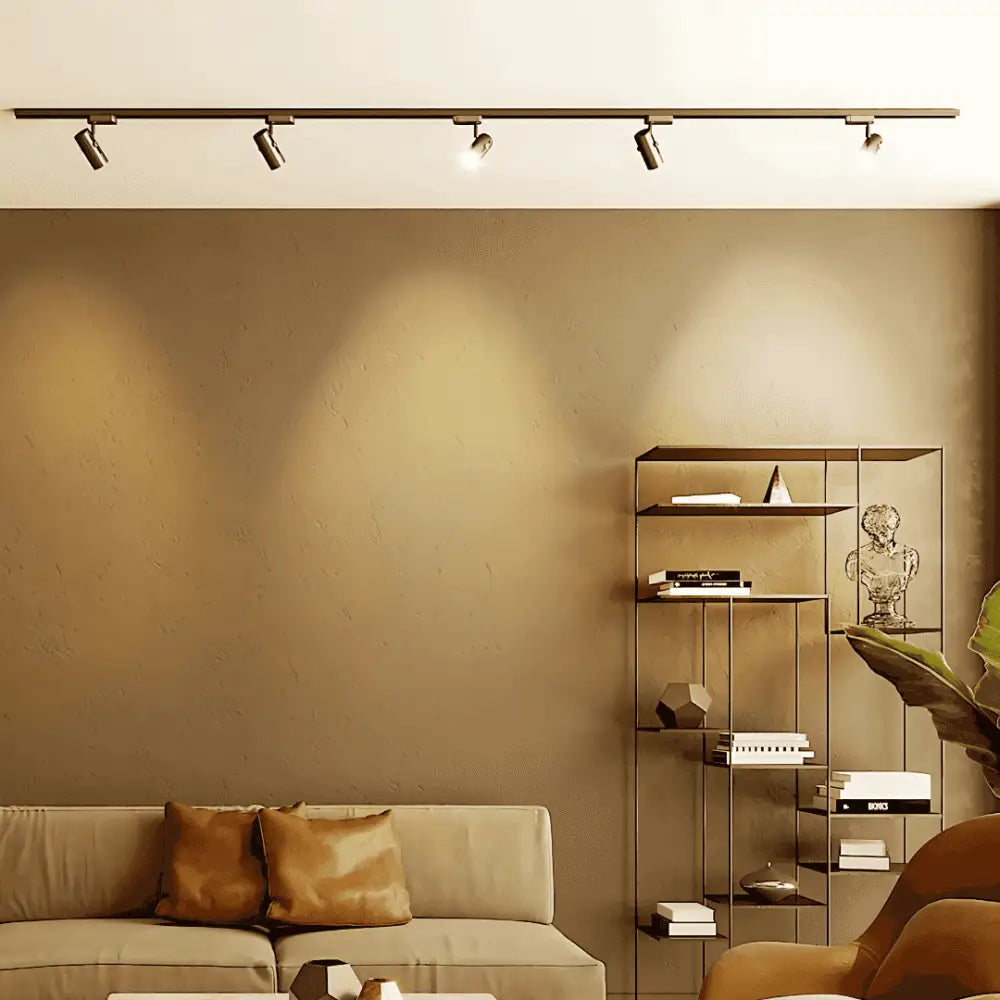 Warm white 8W GU10 dimmable LED bulbs installed in ceiling track lighting, creating cozy ambiance in a modern living room setting.