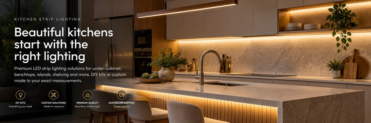 Warm white LED strip lighting illuminating a modern kitchen's cabinets and island