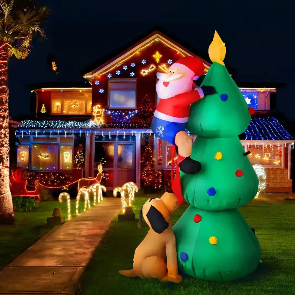 Inflatable Santa Claus and dog with a Christmas tree in front of a house decorated for Christmas.