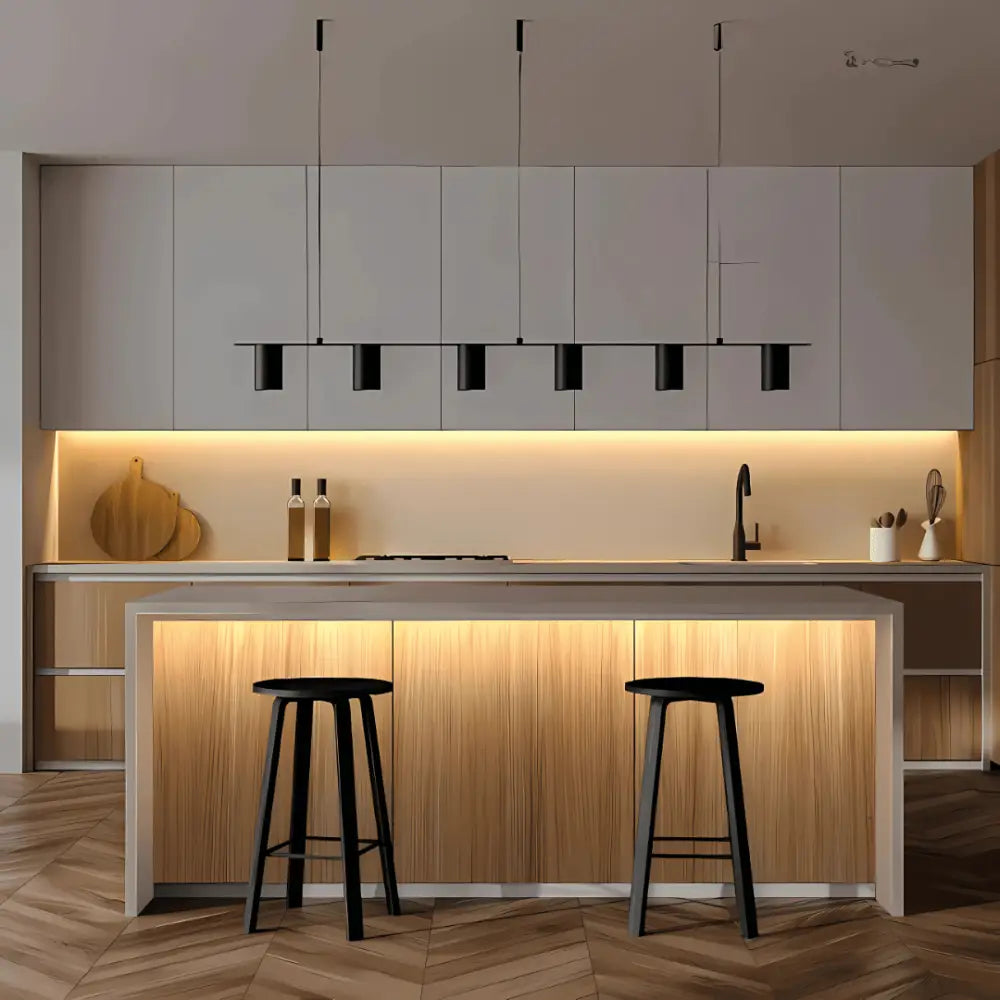 Modern kitchen with Strippy 3000K COB LED Light installed under cabinets and island, providing warm ambient lighting.