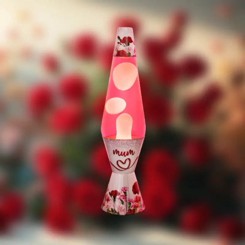 Lava lamp with floral design and 'mum' text against a blurred red flower background