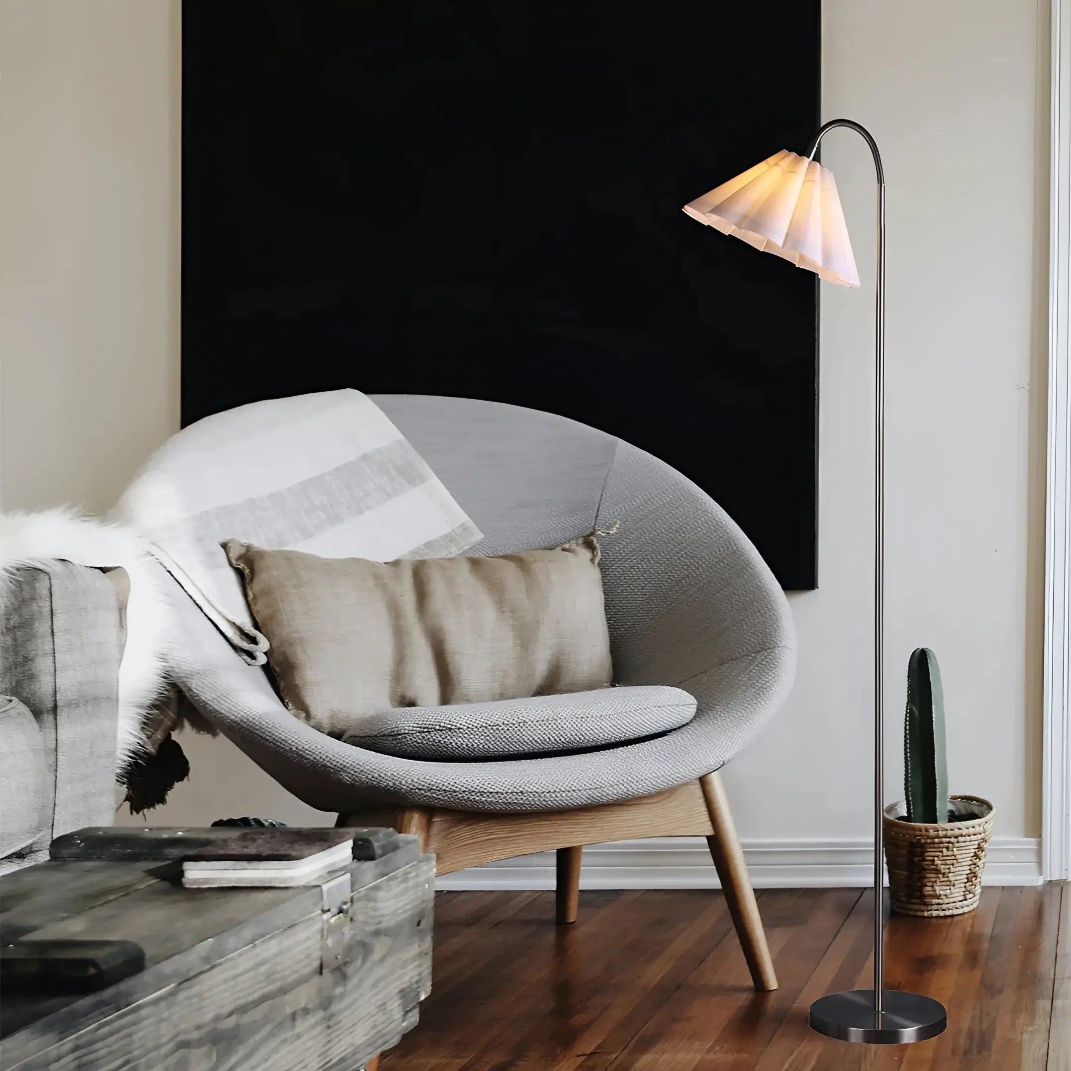 Modern grey fabric armchair with light wooden legs near Lexi Lighting Eleanor floor lamp