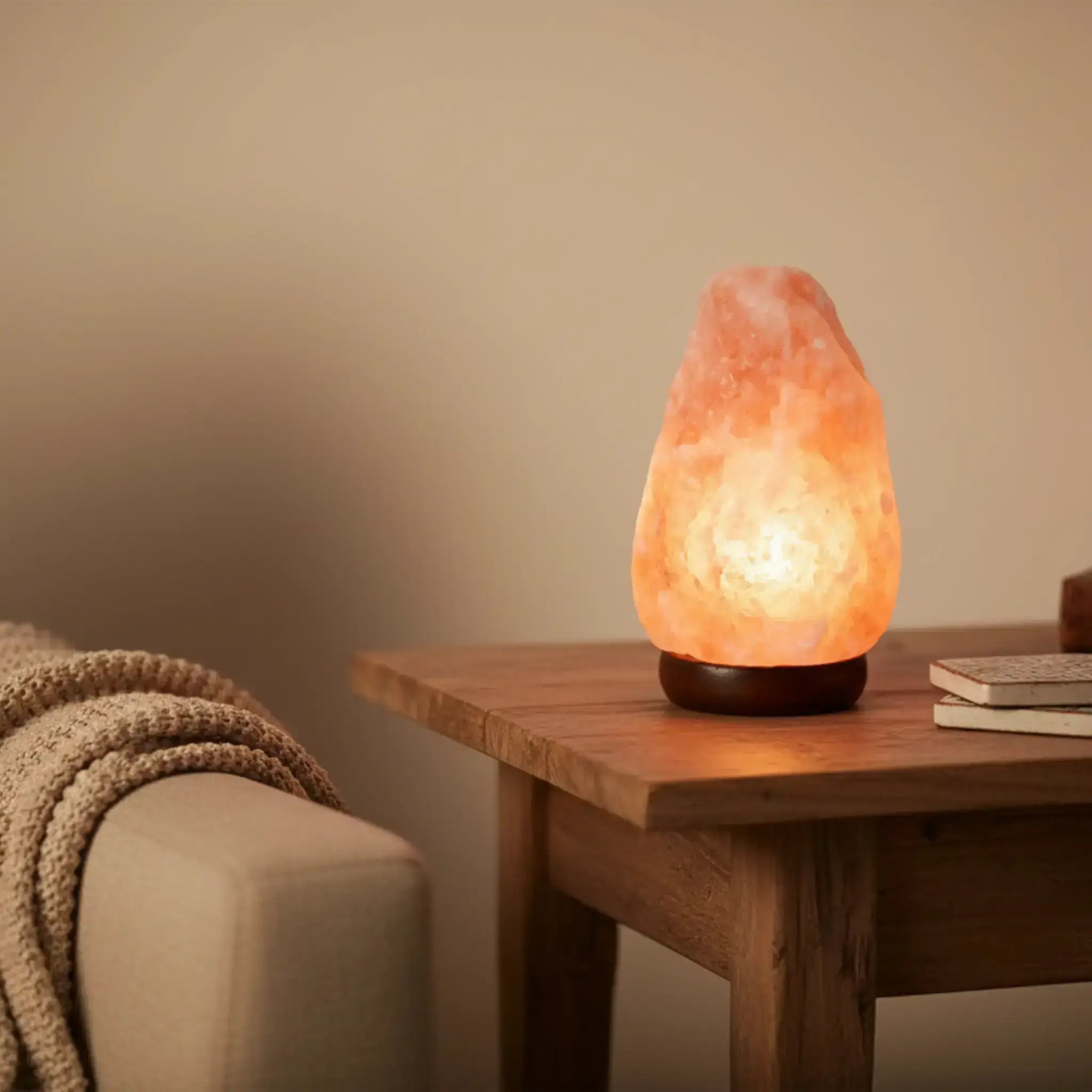 1-2KG Himalayan salt lamp on a wooden table with a cozy background