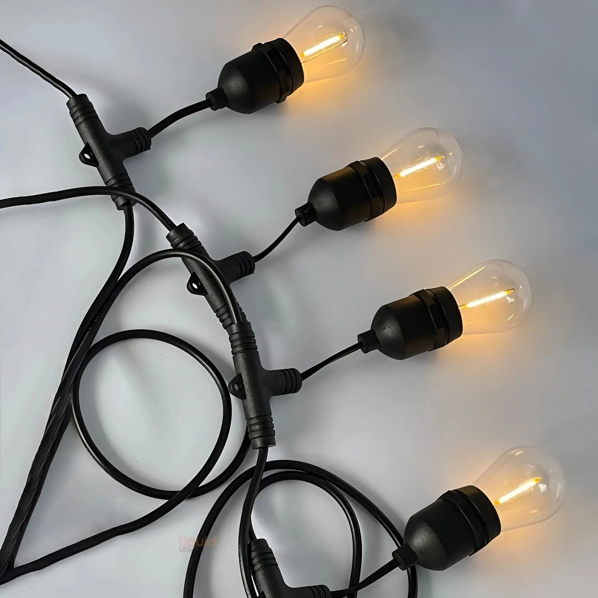15 m solar festoon lights with black string, clear bulbs, warm yellow glow