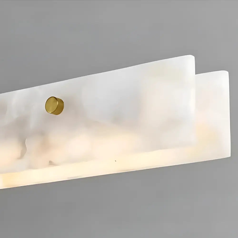Adjustable-height Madison Luxe+ brass and marble LED pendant in a high-end interior