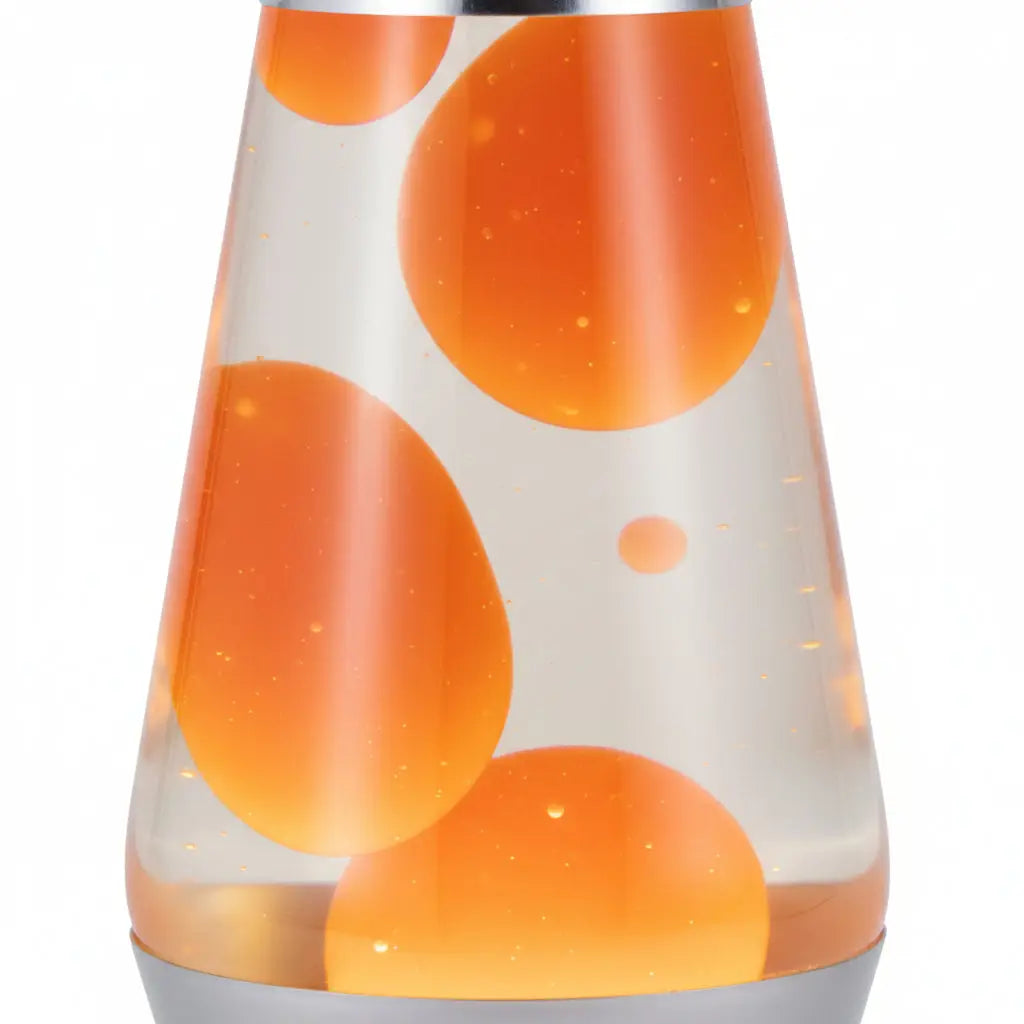A close-up of a clear lava lamp with orange blobs floating in transparent liquid against a white background.