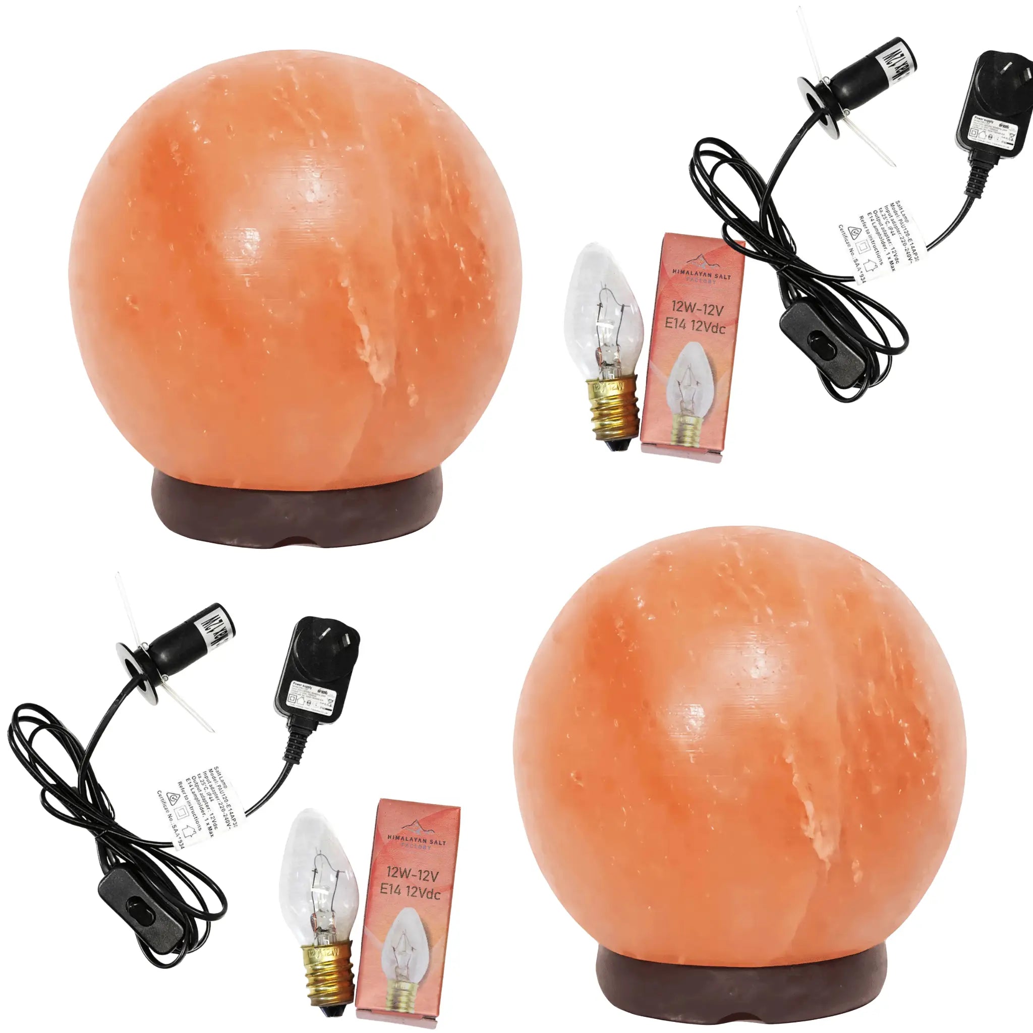 Two orange salt spherical lamps with electrical cords and light bulbs on a white background